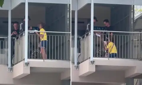 elderly cyclist kneels before two lta officers