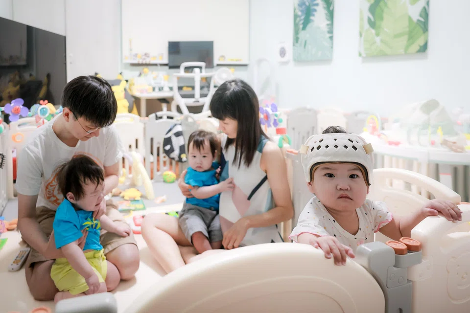 Thirteen-month-old Ng Pei Xuan (front) was diagnosed at six months to have very severe right plagiocephaly and moderate brachycephaly, a result of her continuously sleeping on one side. 