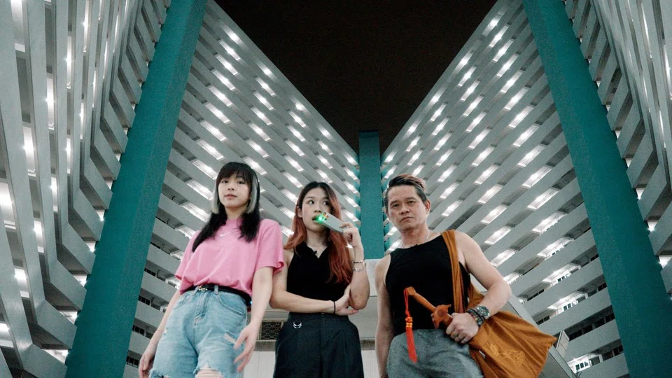 Hosts from YouTube channel Hellbank Asia (from left) Joey Pink, Jazliyana Lee and Maguire Jian at the diamond-shaped HDB blocks at Taman Jurong that is rumoured to have a dark history.
