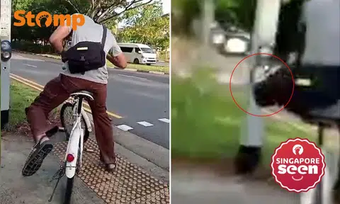 Cyclist uses foot to press pedestrian crossing button