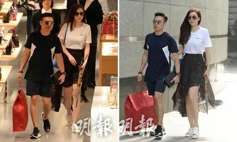 Lynn Hung's husband sits patiently while she chooses handbag