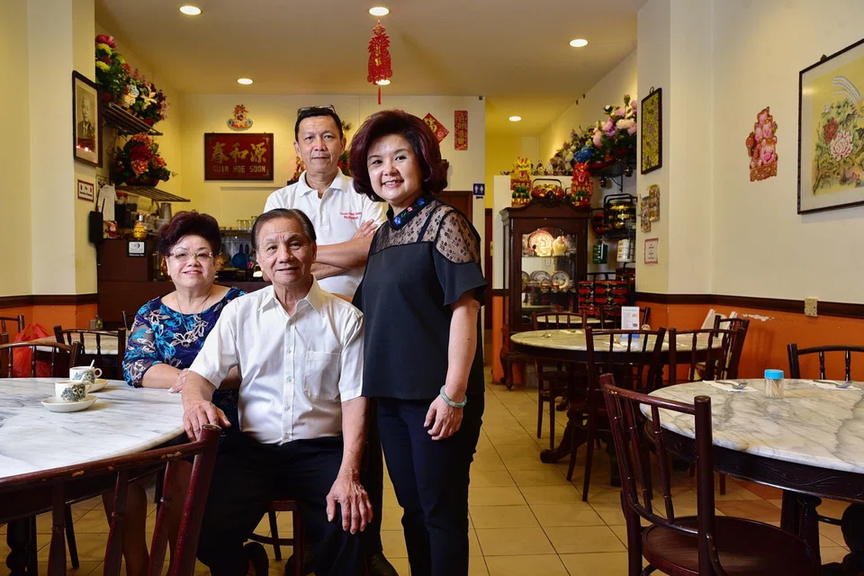 Guan Hoe Soon’s third-generation owner Jenny Yap (right) with her husband Raymond (standing, background) and parents (both seated) Mr and Mrs Yap Kow Soon.
