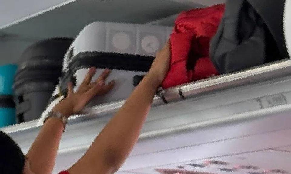 Chinese national caught stealing from overhead luggage on flight to Singapore, hides cash in jacket