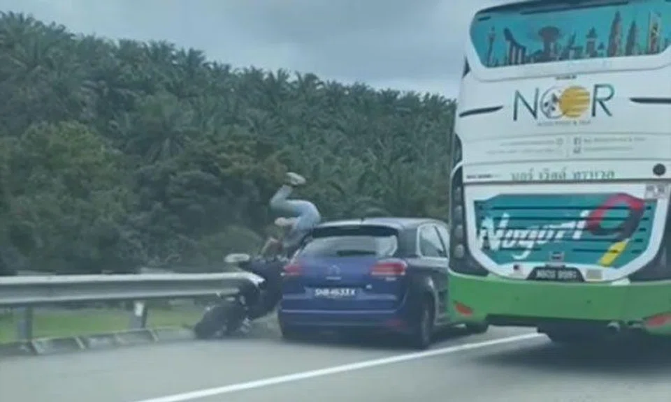  Motorcycle speeding down emergency lane slams into Singapore car on Malaysian highway