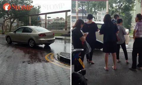 Car parked by the side, while people stand in middle of the road -- to play Pokemon Go