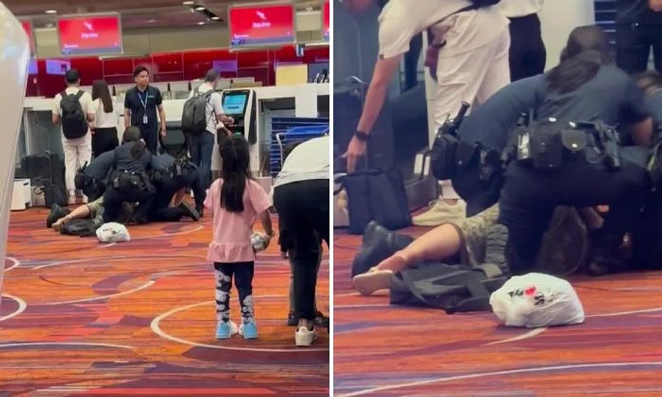 Woman pinned down by 3 cops at airport