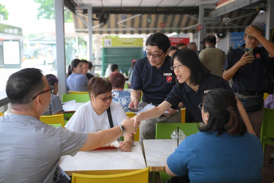 Ms Sharon Lin, 40, a senior consultant in the IT sector, greeting residents around the Chong Pang area on April 13.