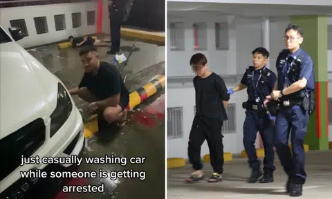 Man washes car in carpark while another man is lying on floor with hands behind back being arrested