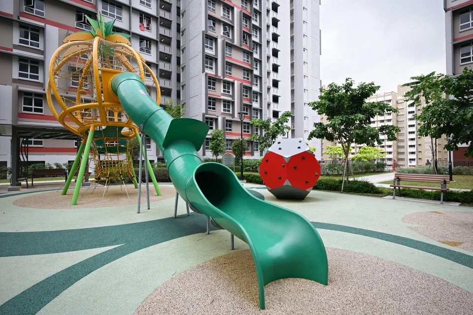 The Ong Lye Garden playground at Block 132A in Tengah has a large yellow pineapple structure with a slide.