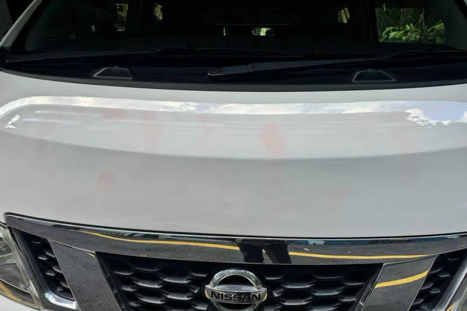 Workers had covered up the graffiti on the white Salvation Army vans by around 3.30pm. ST PHOTO: CHONG JUN LIANG