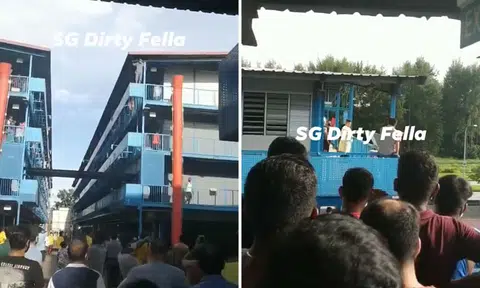 Worker stands on dormitory ledge after dispute with employer over return to home country
