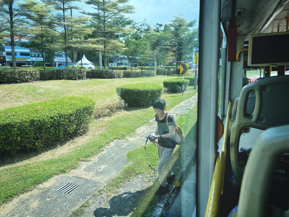 A passenger disembarking at an unmarked bus stop along Jalan Dato Jaafar near the busy Jalan Kebun Teh area in Johor Bahru on June 4.