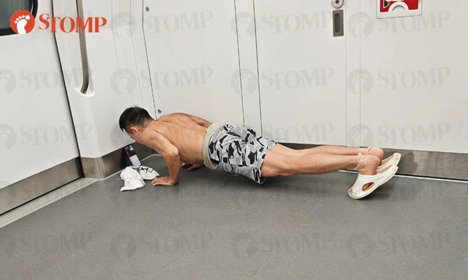 Topless man does push-ups on MRT train -- and even records himself