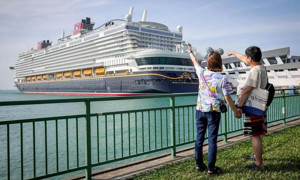 Two passengers pose for a photograph ahead of the Disney Adventure’s maiden voyage on March 10. The cruise will roll out a US$5 (S$6.40) delivery charge for in-room dining orders from June 4.