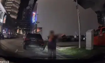 Woman standing in a parking lot to reserve it