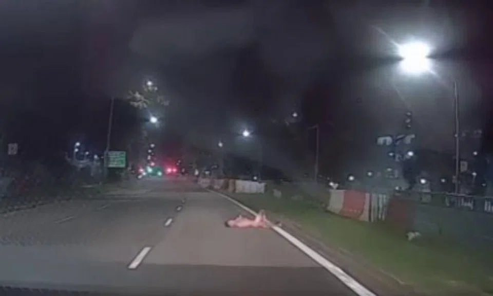 A 34-year-old man has been arrested after a video shows him lying naked on a road in Sembawang.