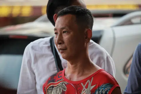 Xiao Xiezhi is facing three charges of allegedly offering bribes amounting to more than $400 to three NEA enforcement officers on Jan 22, after being caught smoking under a bus stop shelter.