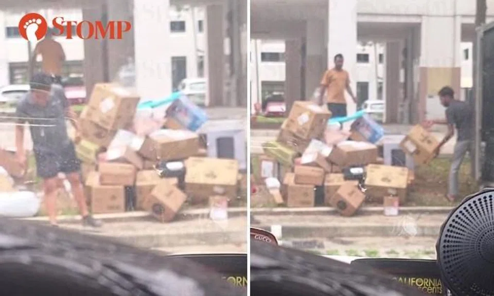 Workers unload parcels by tossing them onto ground as their boss spits in Dakota carpark