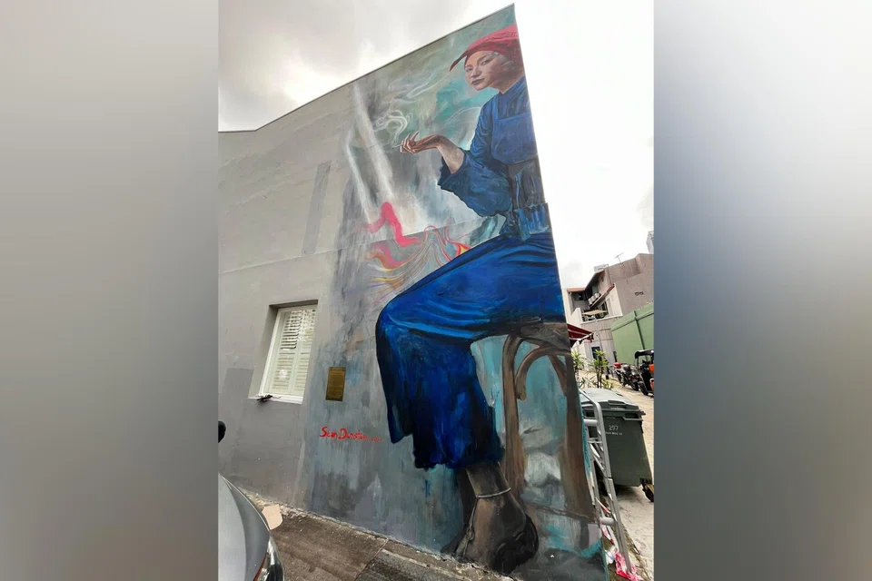 The plaque has been installed at the bottom left-hand corner of the mural.