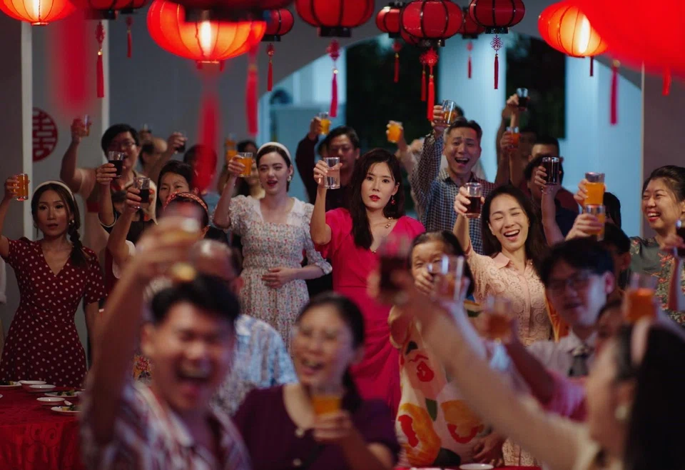 Carrie Wong (in red dress) played a chain-smoking, vulgarity-spewing mother in the local movie Ah Girl.