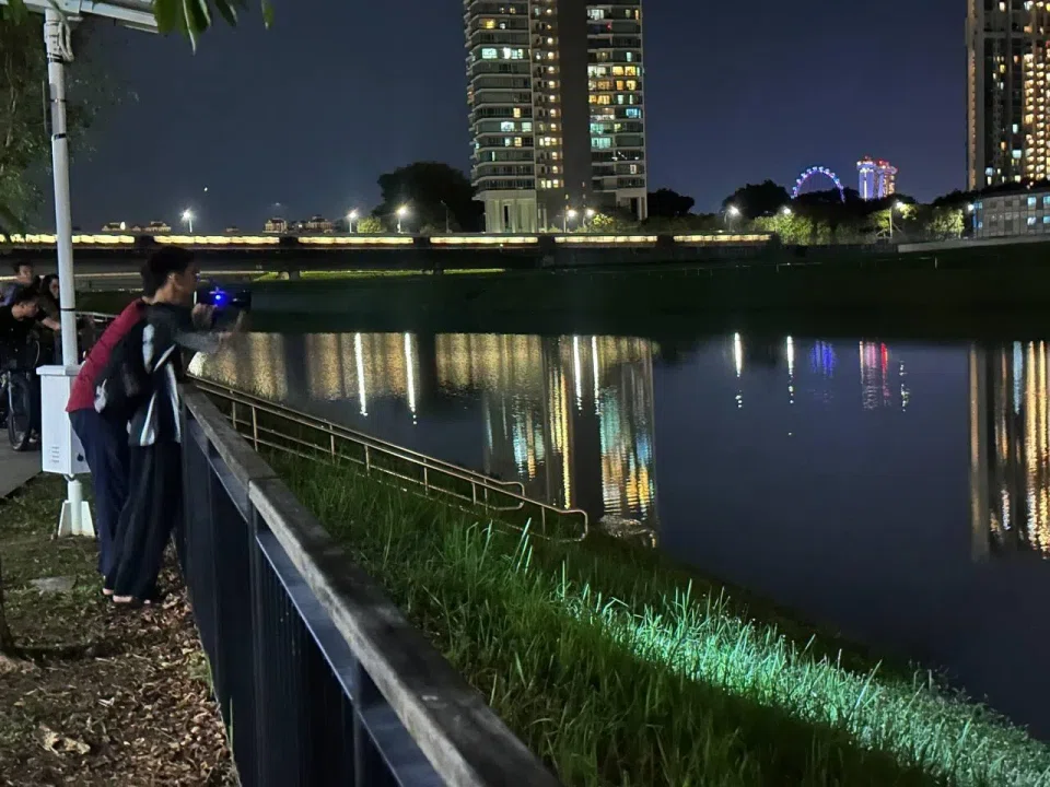 Family members scanning the Kallang River during their search for Daniel on Feb 26. ST PHOTO: ZAIHAN MOHAMED YUSOF