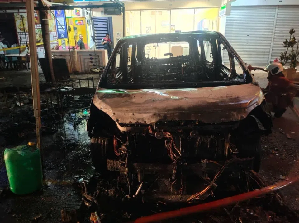 The remains of a car after a fireworks stall next to it in Cheras, Selangor, caught fire.