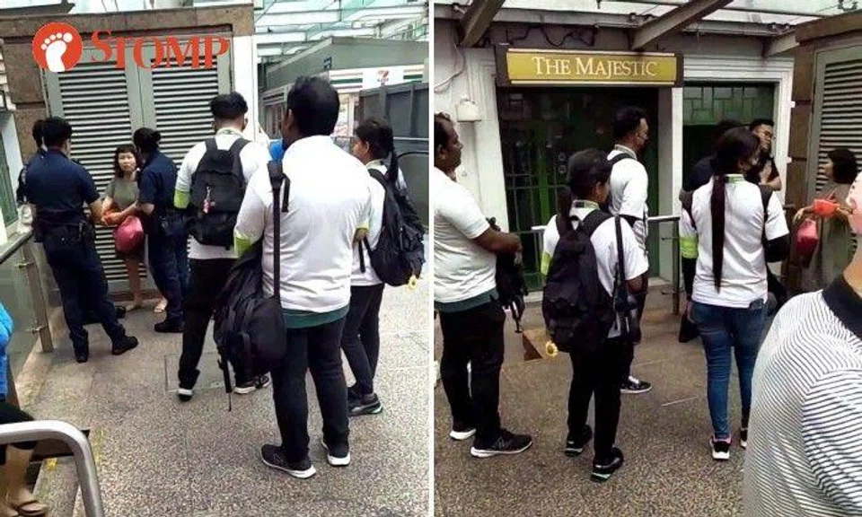 Stomper Raven shared a video of three police officers surrounding the woman with near exit C of the Chinatown MRT station. 