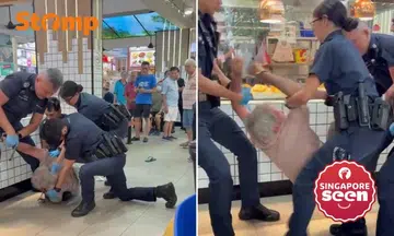 Elderly man struggles with police in coffee shop