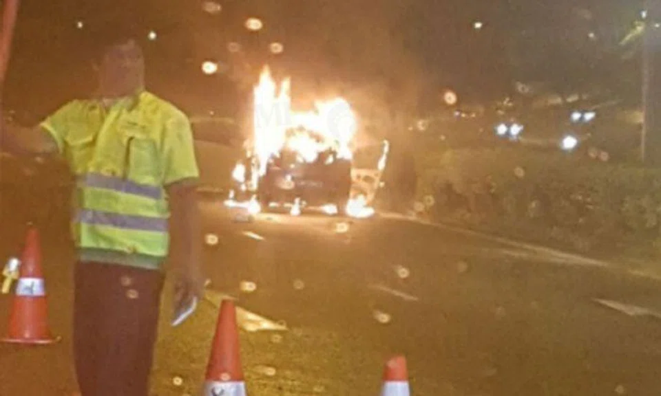 A car caught fire on the Pan-Island Expressway (PIE) on Wednesday evening (Jan 10), causing a traffic jam. (PHOTO: TELEGRAM/SGROADBLOCKS/TRAFFIC NEWS)
