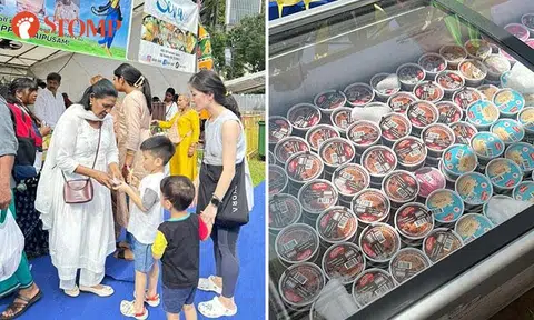 Volunteers hand out free ice cream to devotees and passers-by during Thaipusam festival
