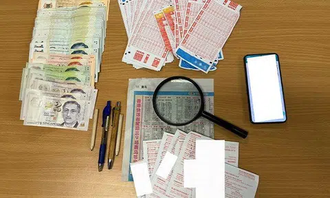 Cash and gambling paraphernalia seized at Bukit Batok. PHOTOS: SPF