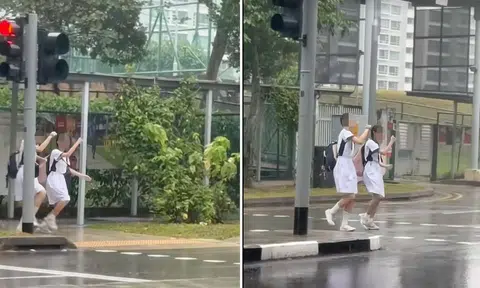 nan hua high school students dance in the rain while crossing road