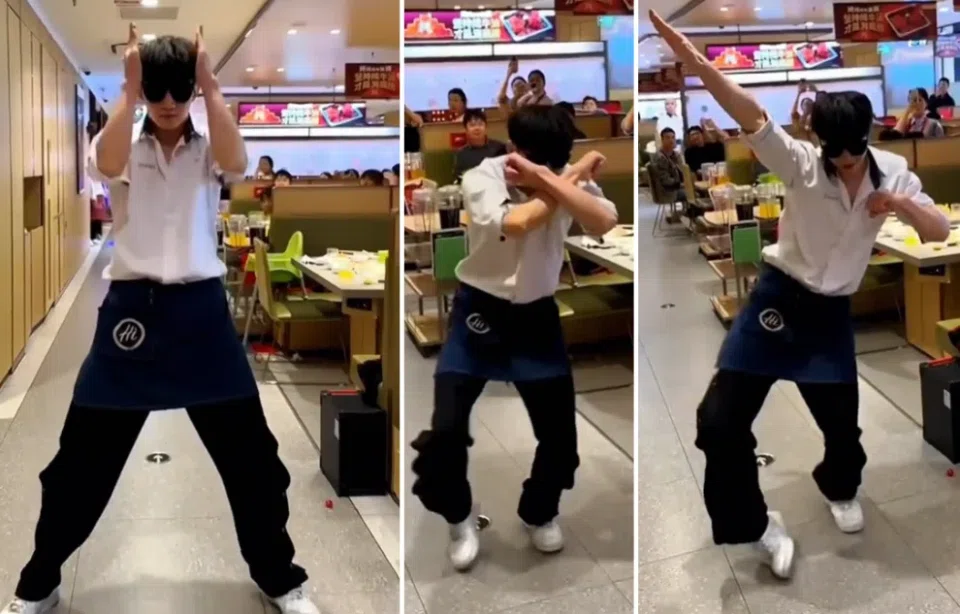 A Haidilao employee performing the Ke Mu San.