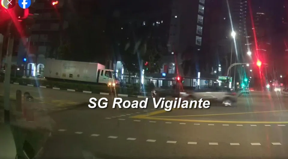 A cyclist can be seen riding across one side of the junction, and appears to be going against a red traffic light.