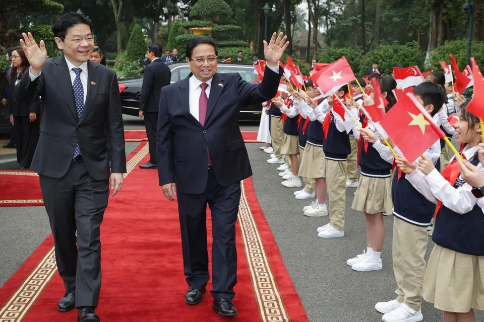 Prime Minister Lawrence Wong and his Vietnamese counterpart Pham Minh Chinh at a welcome ceremony at the Presidential Palace in Hanoi on March 26.