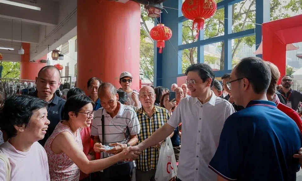 Prime Minister Lawrence Wong greeting patrons at Chinatown Complex on Jan 4.