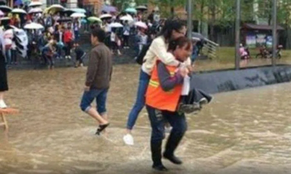 Netizens irked by Chinese college students getting piggybacked across ankle deep waters