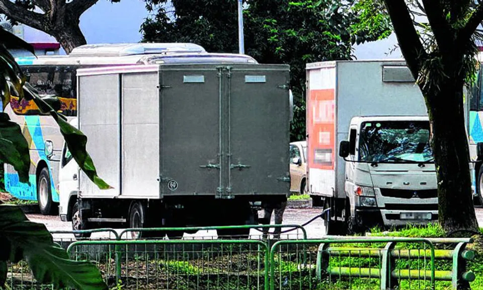 Minibuses and lorries were spotted refuelling from the lorry with the covered back. PHOTO: LIANHE ZAOBAO