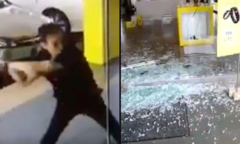 Disgruntled Malaysian man shatters glass panels at telco service center with golf club in Sibu