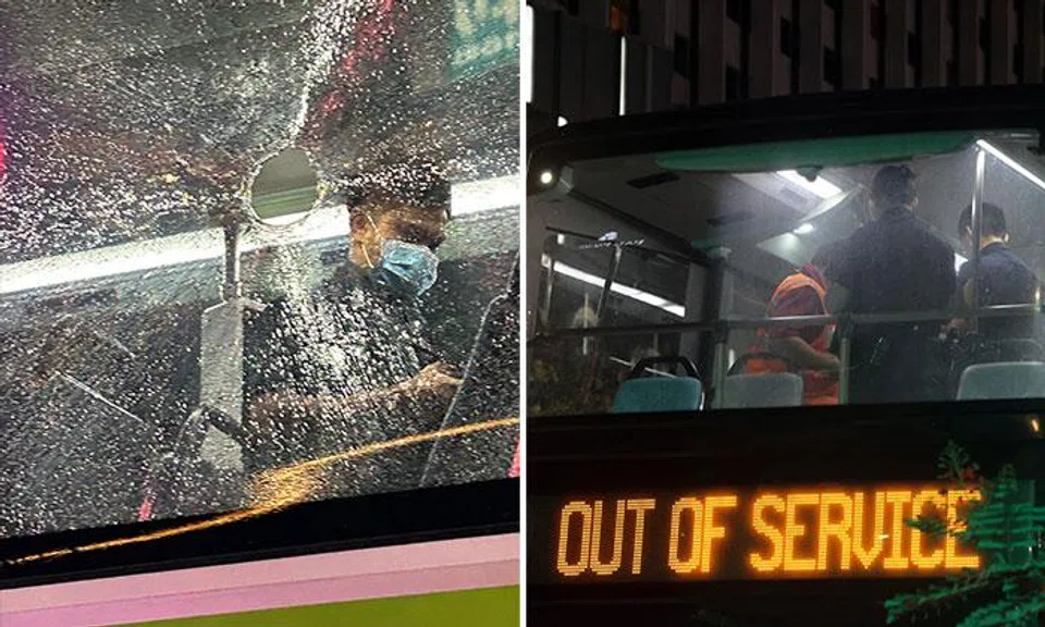Someone, believed to be a person in the street, threw a bottle at the bus that left a hole in its window.