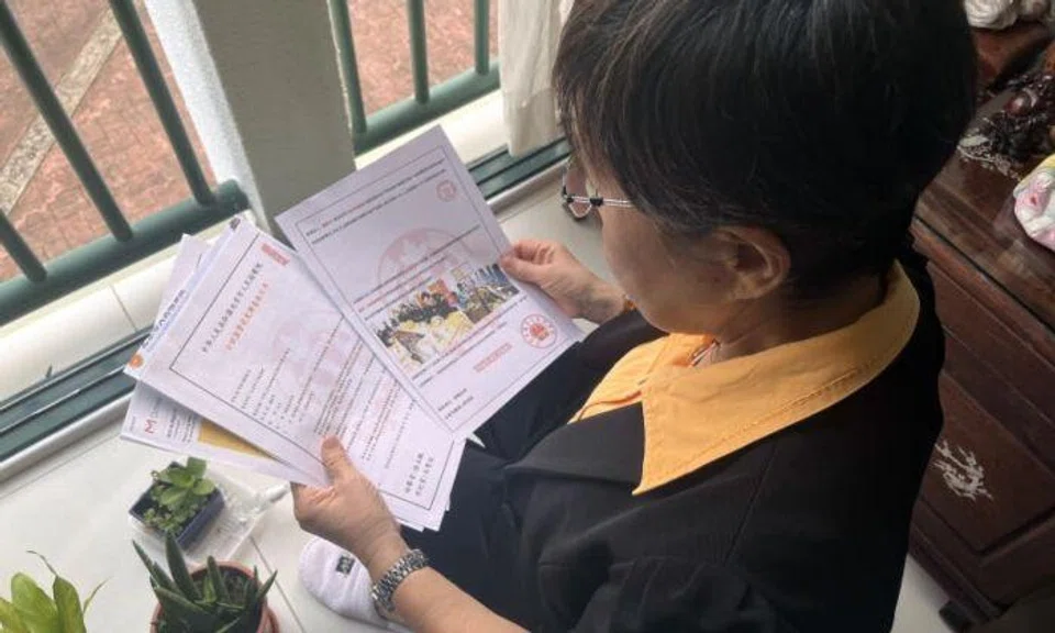 Preying on her distress, the scammer offered to help her. They even got a female “police officer” to hand her documentation of her “crimes” as proof. Photo: Lianhe Zaobao