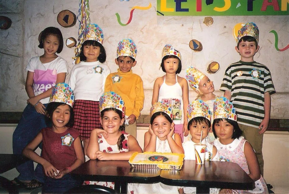 Roberts (front row, in front of cake) celebrating her seventh birthday at a McDonald's restaurant in Hougang with her schoolmates from Parry Primary School, and some family friends. Parry Primary School merged with Xinghua Primary School in 2007.