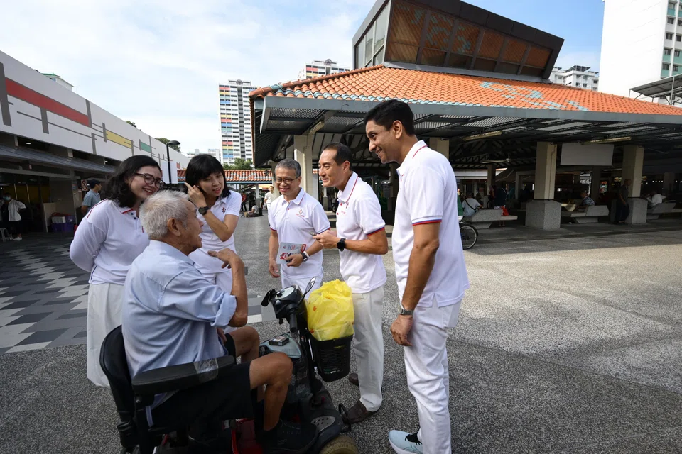 PAP’s East Coast GRC candidates (from left) Hazlina Abdul Halim, Jessica Tan, Edwin Tong, Tan Kiat How and Dinesh Vasu Dash meeting a resident during a walkabout at The Marketplace @ 58 in New Upper Changi Road on April 24.