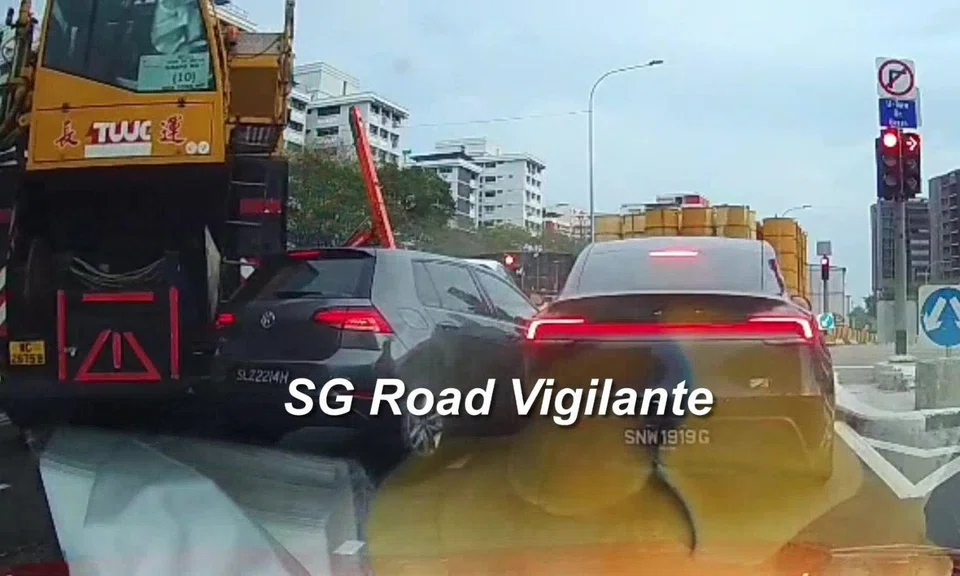 The mobile crane's rear swung into an adjacent car as it was turning. 