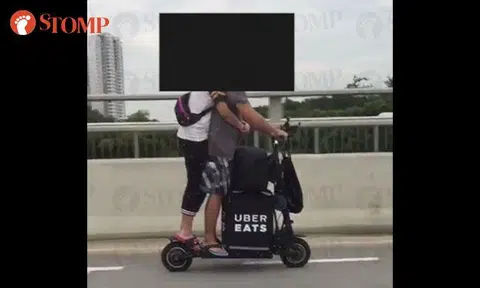 UberEATS delivery couple riding e-scooter at Bedok South is an accident waiting to happen