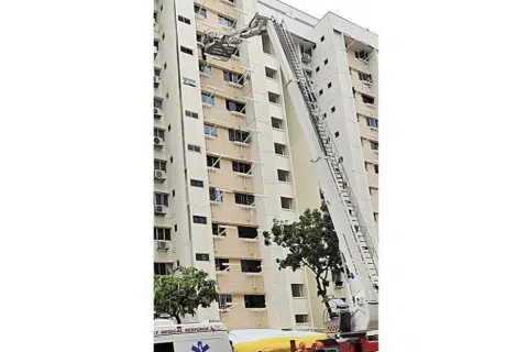 Maid stuck on 10th-storey ledge after stepping out to clean window