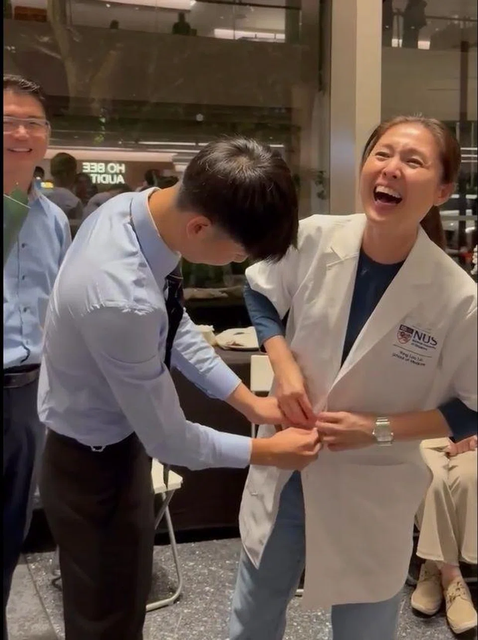 In the middle of posing for photos at the event, Joel, who was dressed in the coat, removed the garment and placed it on his mother, who began beaming from ear to ear.