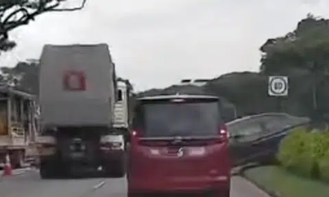 The car ended up on the median strip on Bedok North Flyover after switching lanes to avoid the stalled vehicle in the left-most lane.