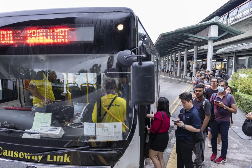 Commuters queue to board the Causeway Link bus to Johor Bahru on April 9.