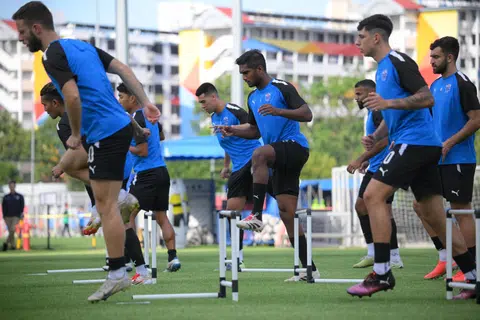 Lion City Sailors captain Hariss Harun putting his best foot forward with Lionel Tan and other teammates during training.